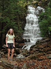Zhanna, freezing cold and in the midst of a laughing fit at Buttermilk Falls, near the Bear Creek Falls geocache.