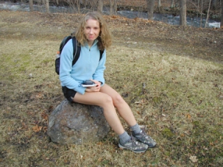 Zhanna finds a comfy seat on a chunk of iron ore.