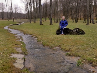 Further upstream, Zhanna admires how the entire creekbed is lined with coping stones.