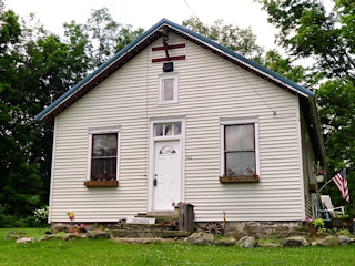 Closeup of the front of the restored schoolhouse.