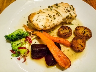 Halibut in herb-butter sauce with roasted vegetables