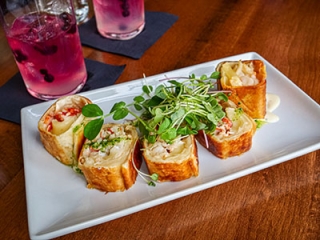 "French Lobster Roll" with lobster, brie, and caramelized onions rolled in griddle-crisped tortilla