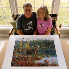 Rich and Zhanna in the sunroom, with a moose puzzle.