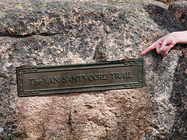 A bronze plaque commemorates the efforts of a once prolific trail-builder.